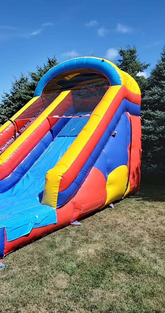 Colorful bounce house with an attached slide