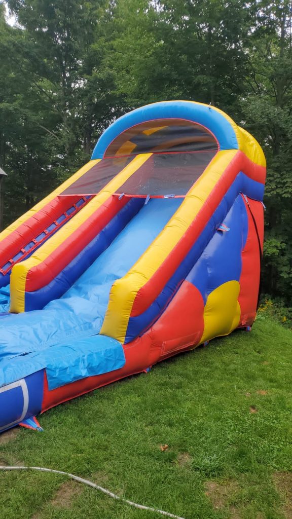 Colorful bounce house with an attached slide