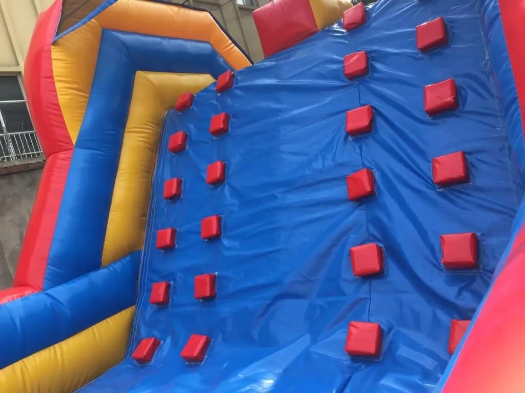 Bounce house with attached climbing wall